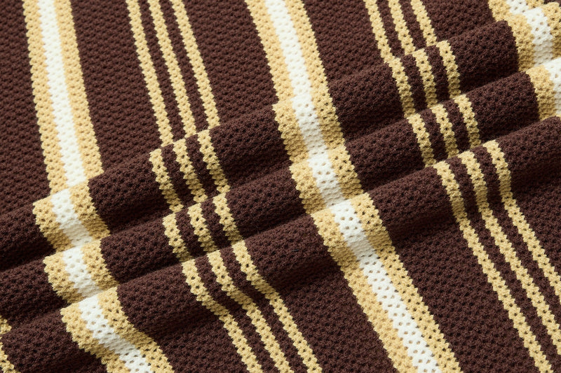 Close-up of brown retro knit polo fabric with cream and white collegiate-style stripes and textured cotton weave