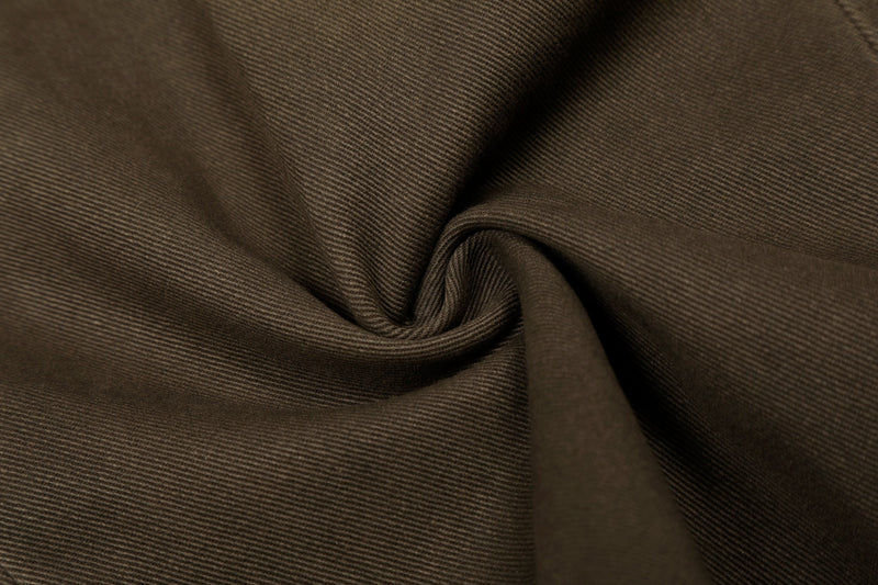 Close-up of brown cotton fabric texture with soft folded drape