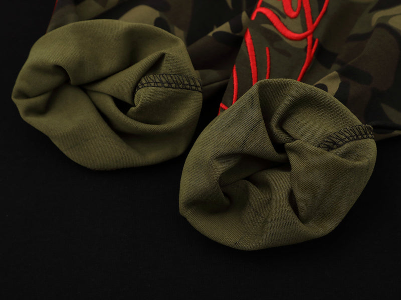 Close-up of sleeve cuffs and seam finishing on camouflage raglan long sleeve tee