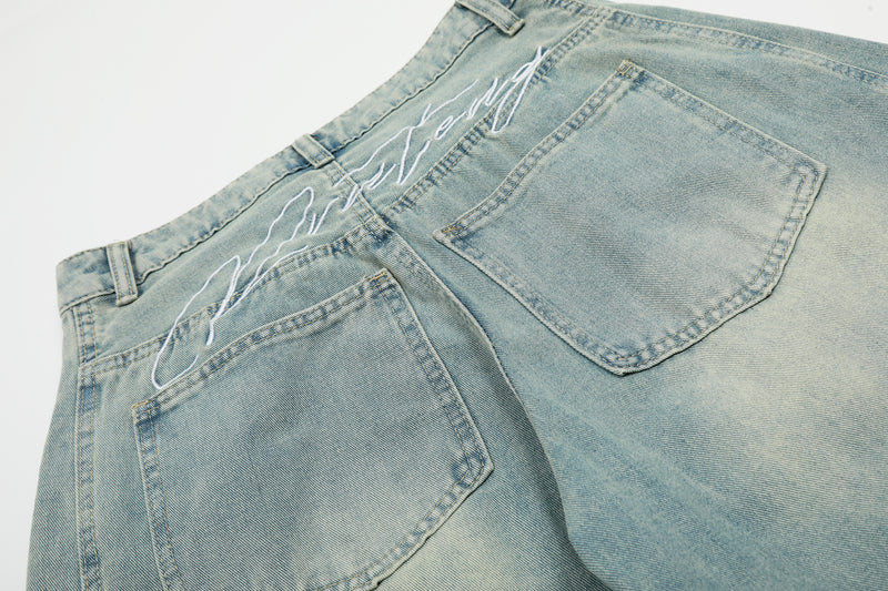 Close-up of back waistband and pockets on light wash denim jeans