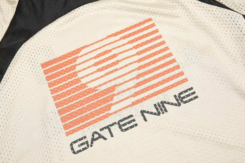 Close-up of a cream mesh sports jersey with orange striped graphic and black Mafaerror lettering, streetwear style