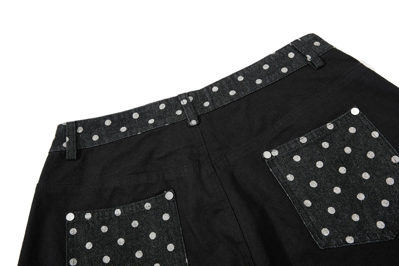 Back view of black wide-leg jeans with polka dot pocket panels and waistband