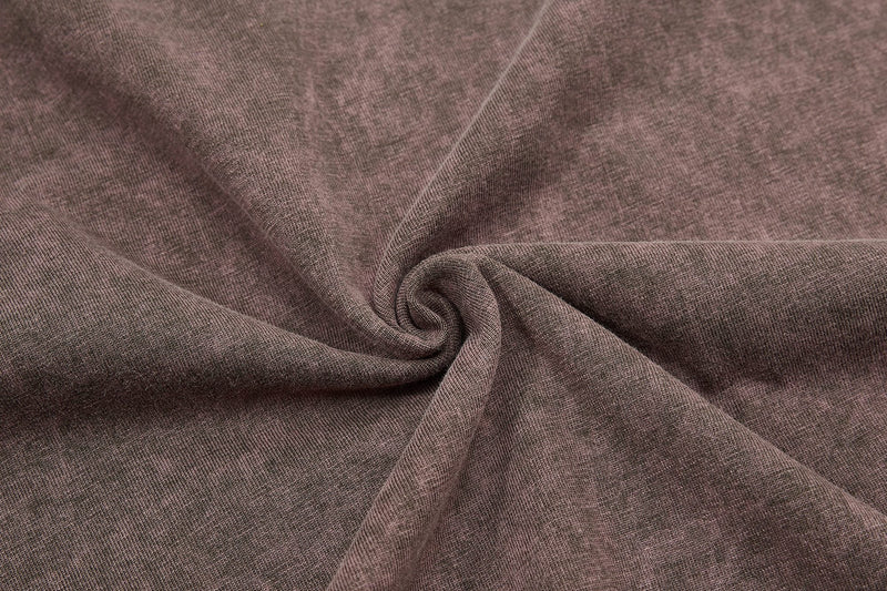 Close-up of a washed brown raglan tee fabric with soft vintage texture and relaxed coastal streetwear feel