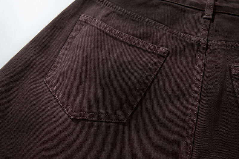 Close-up of the back left pocket on brown washed denim