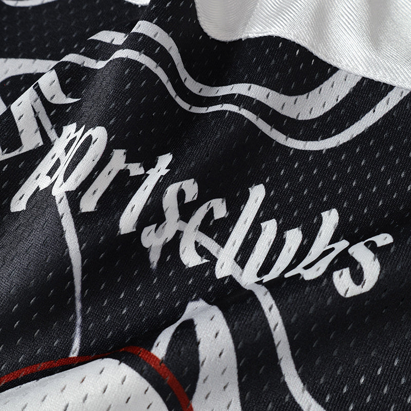Close-up of black swirl camo football jersey fabric with white streetwear graphics and red trim details