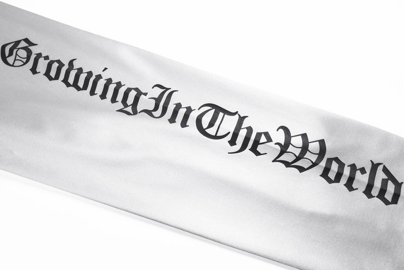 White sleeve detail with black gothic script along the arm