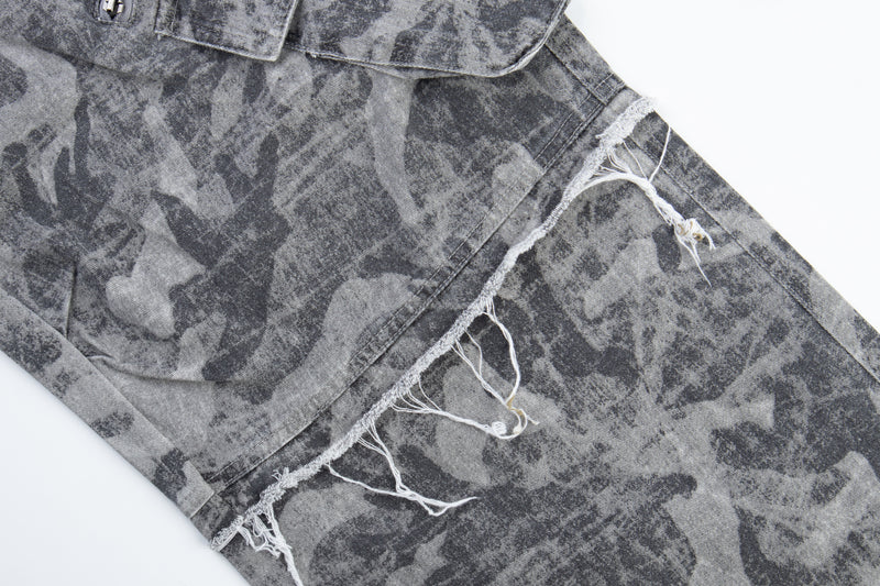 Close-up of gray camo pants thigh patch and frayed seam detail