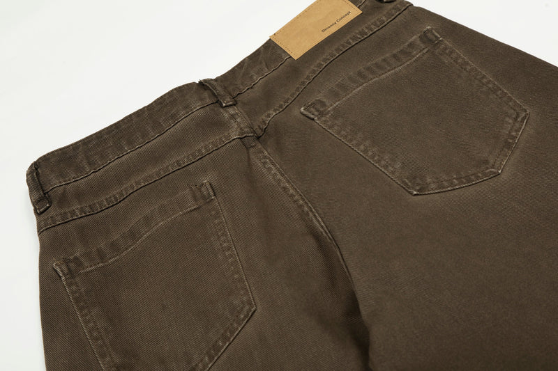 Back waist close-up of brown cargo pants with tan label at the waistband