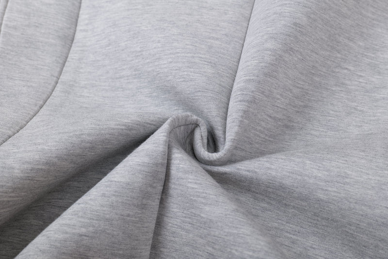 Close-up of light gray hoodie fabric draped in soft folds