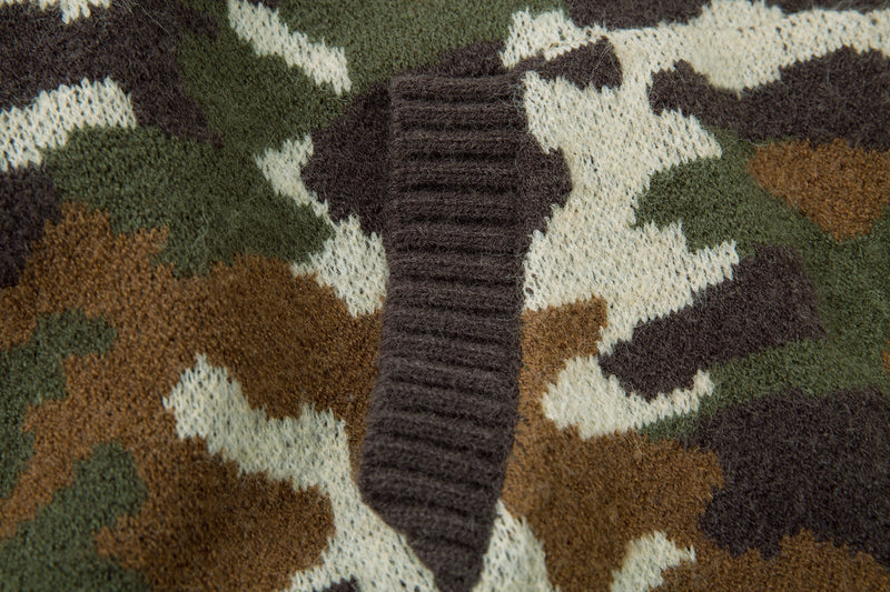Close-up of a ribbed hoodie pocket on olive and brown camouflage knit fabric