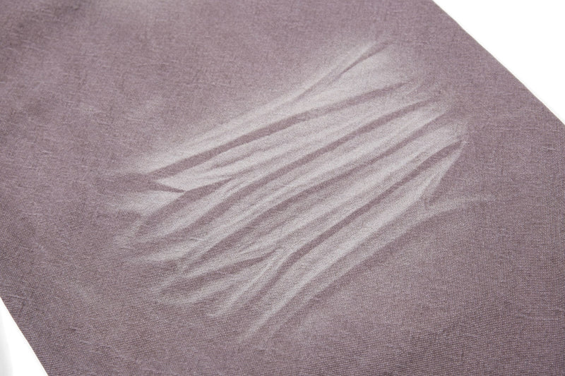 Close-up of brown denim faded wash texture