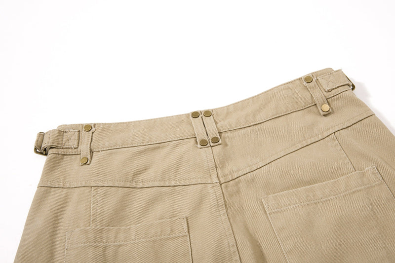 Close-up of khaki waistband with snap tabs and belt loop details