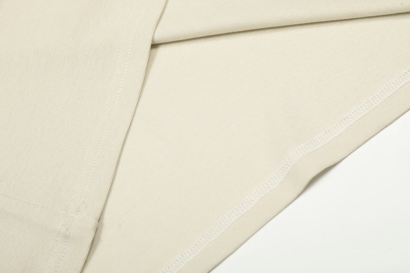 Cream side seam close-up showing stitching and knit texture