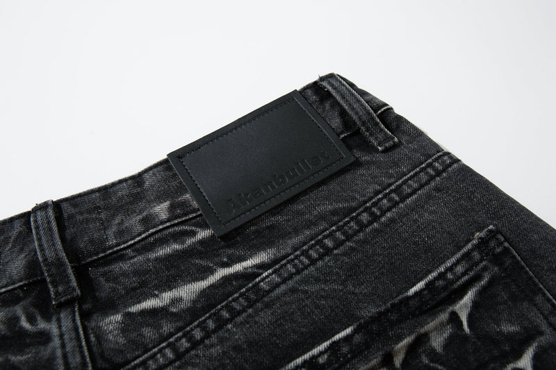 Close-up of the back waistband patch on black jeans with cracked wash