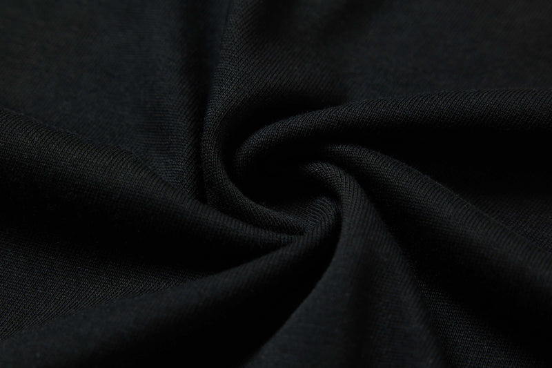 Close-up of black cotton fabric with soft folds, showcasing the textured material of a Seakoff street style graphic tee