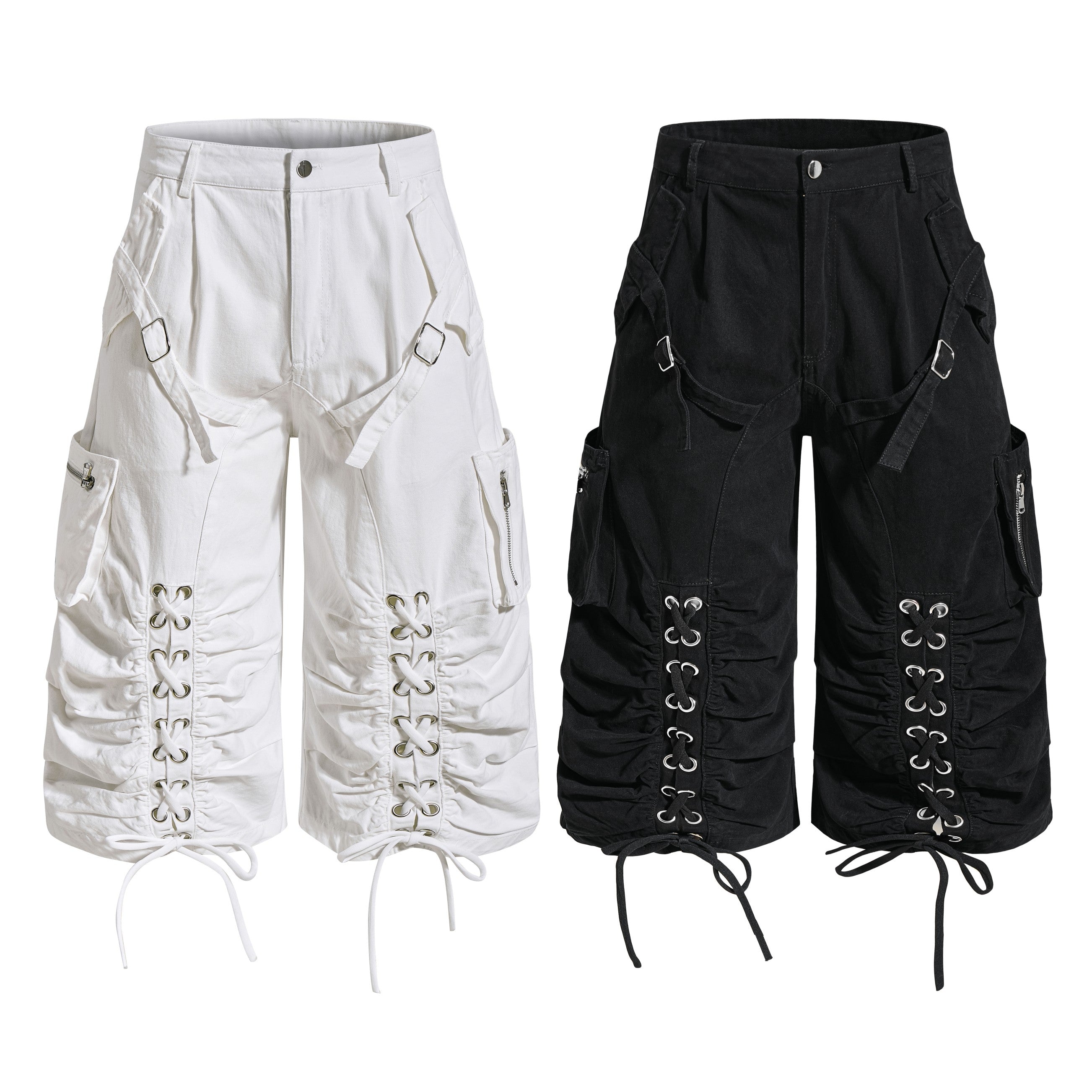 White and black lace-up utility cargo shorts with metal eyelets, ruched leg panels, and buckle hardware shown side by side