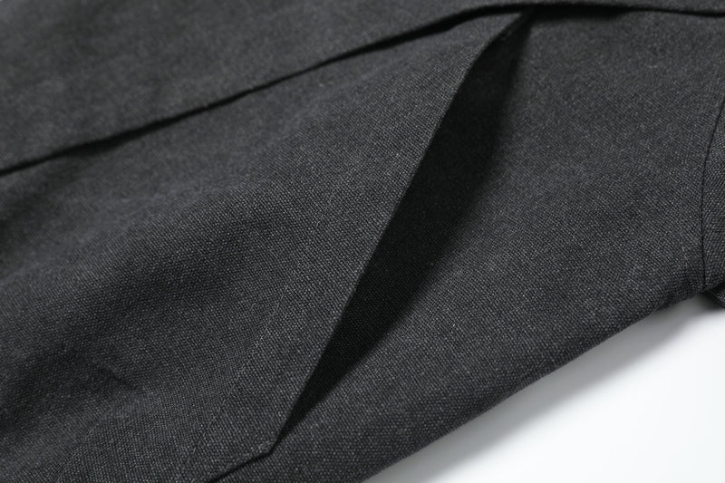Close-up of black woven jacket fabric with diagonal seam detail