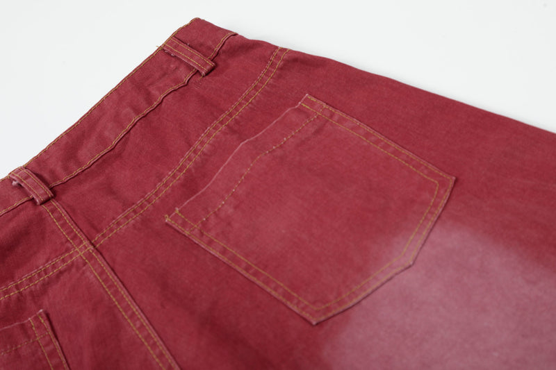 Close-up of back pocket and waistband on red wide-leg jeans