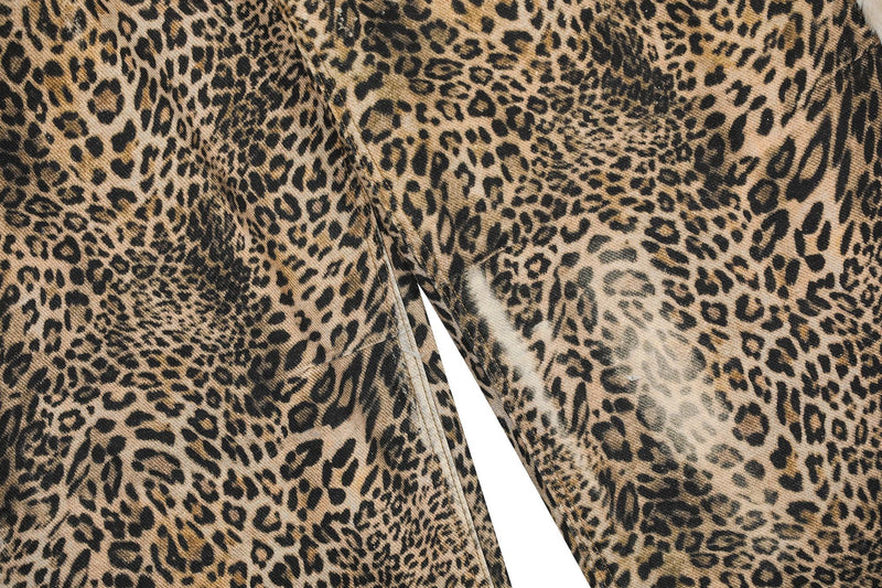 Close-up of leopard print denim with center seam and leg drape