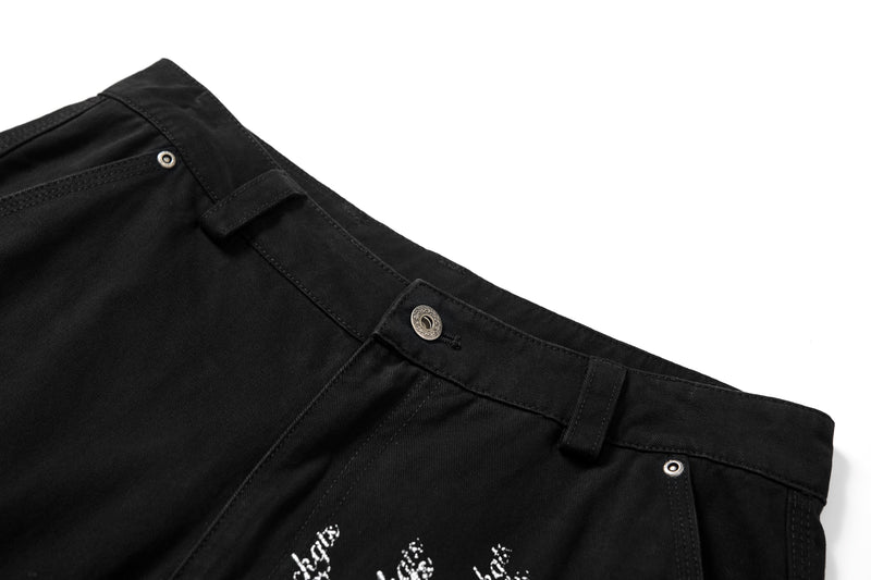 Close-up of black cargo pants waistband with belt loops and metal snap button