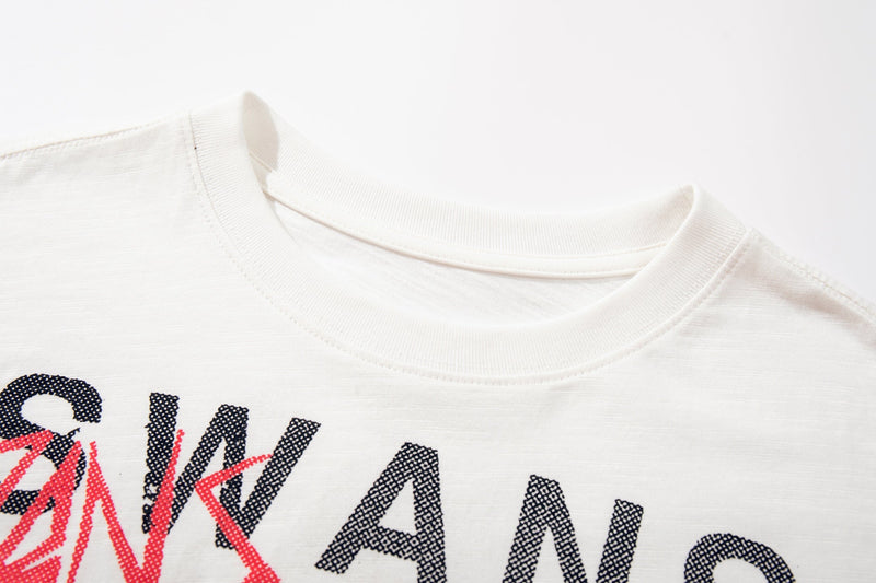 White Seakoff SWANS SINS graphic T-shirt with bold black and red punk lettering close-up on the neckline and chest print