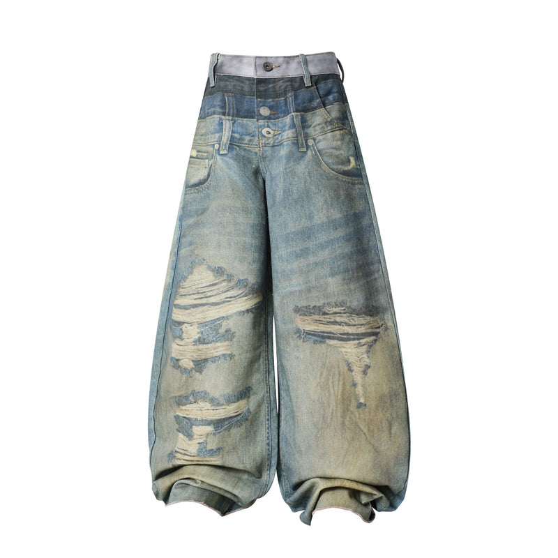Front view of wide leg distressed balloon jeans with layered blue and gray fade