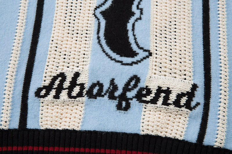 Close-up of script text across the front of light blue striped knit sweater