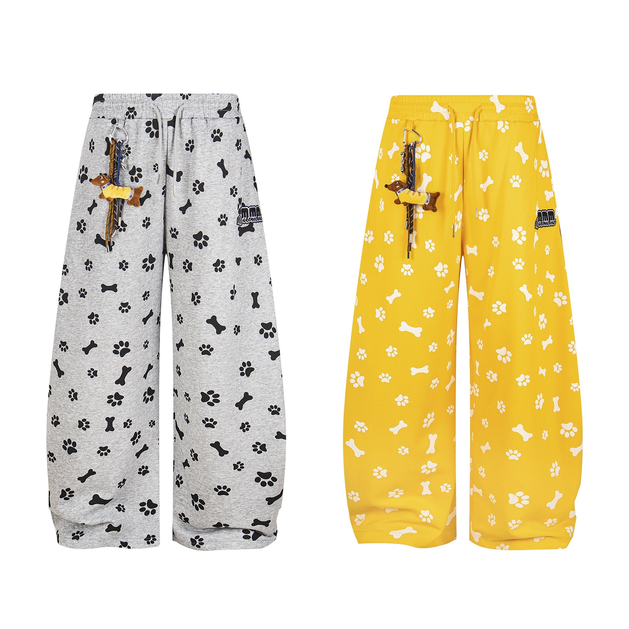 Grey and yellow wide-leg lounge pants with all-over dog paw and bone print, shown front view with detachable dachshund keycha