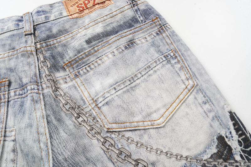 Close-up of the back pocket and waistband on faded blue patchwork jeans
