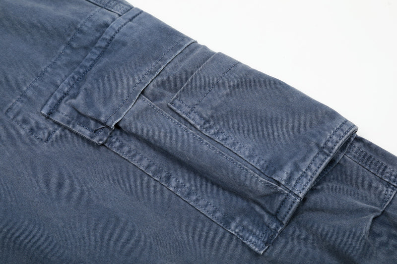 Close-up of washed blue cargo pants lower leg with cargo pocket seam