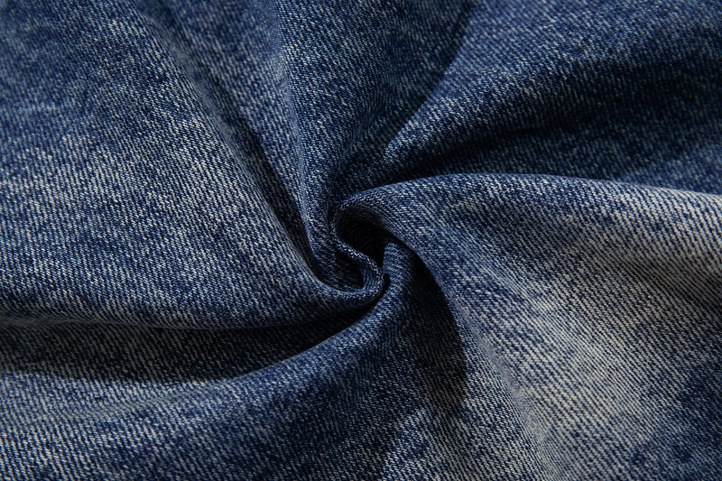 Close-up of blue denim fabric texture with soft faded weave