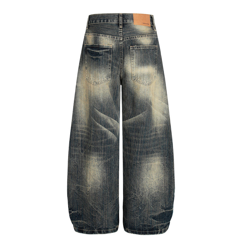 Back view of wide-leg denim pants with patch pockets and leather waistband label