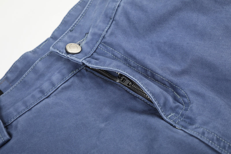 Close-up of blue cargo shorts front pocket zipper under the waistband