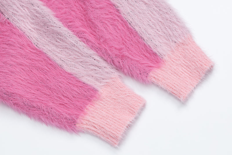 Close-up of pink and light pink fuzzy knit sleeve stripes with ribbed cuff