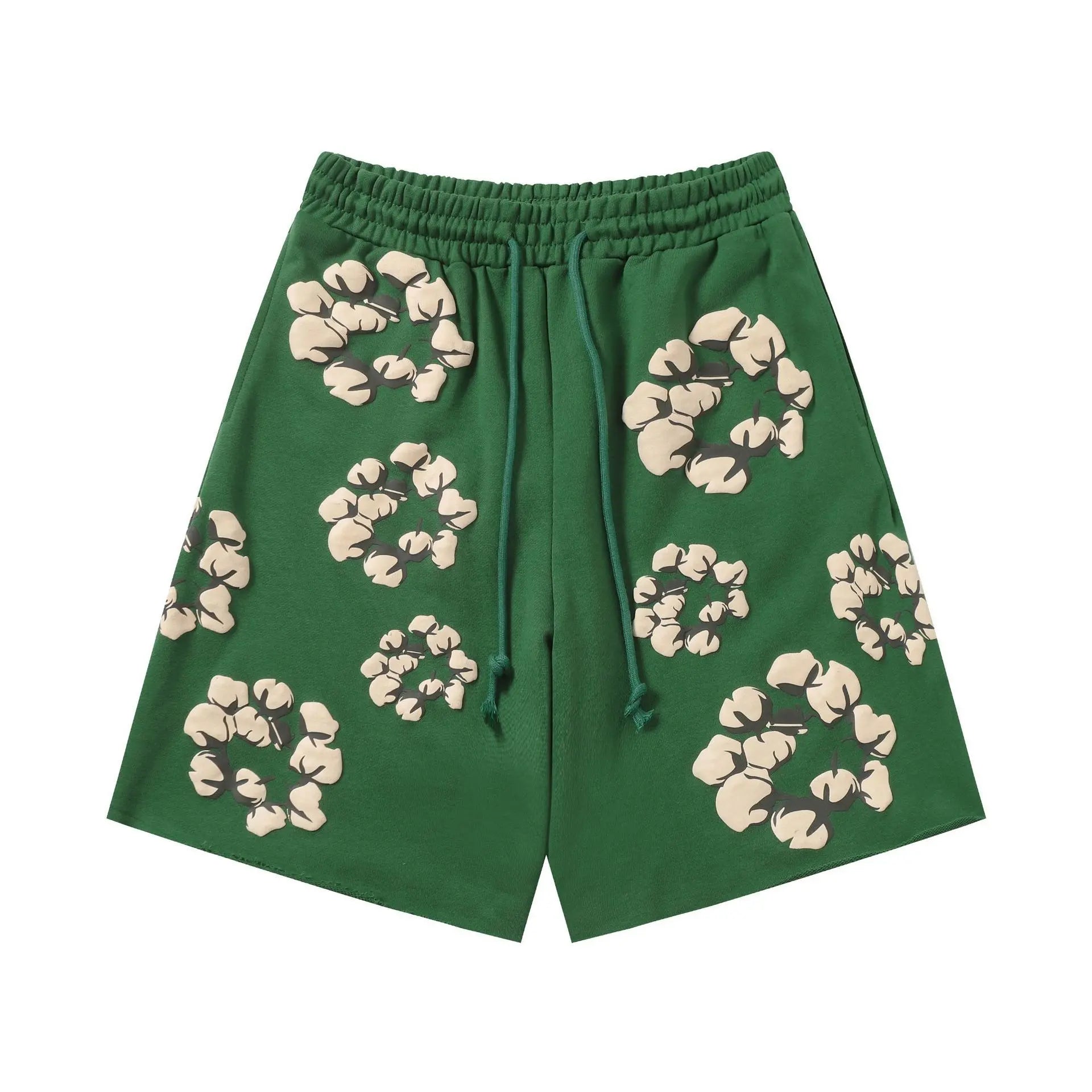 Green Denim Tears jogger shorts with allover cotton wreath print and drawstring waist, flat lay view