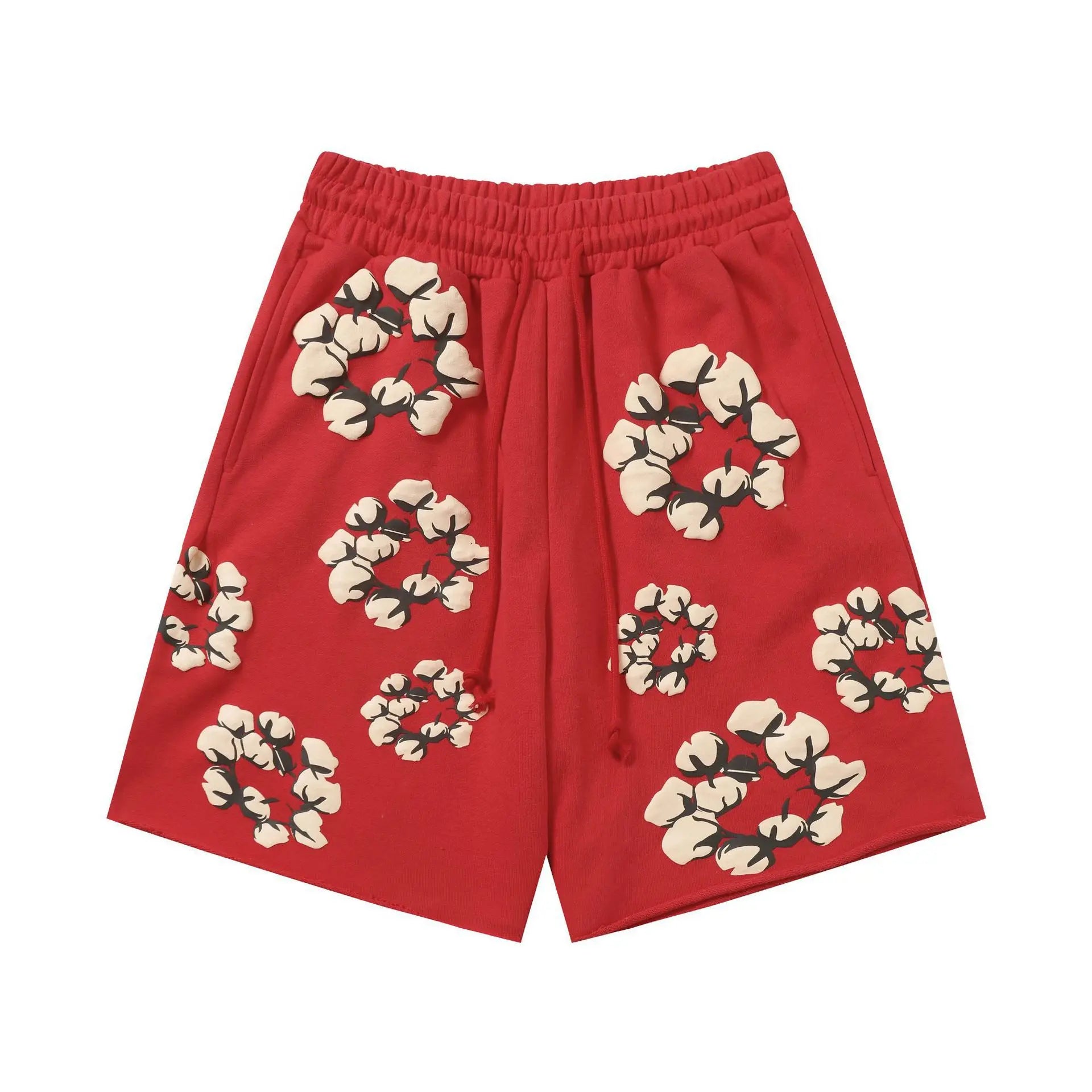 Red oversized cotton shorts with allover cotton wreath print and elastic drawstring waistband, flat lay on white background