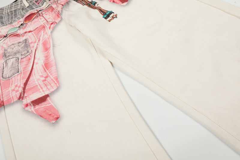 Close-up of cream wide-leg denim leg with pink print panel along the side