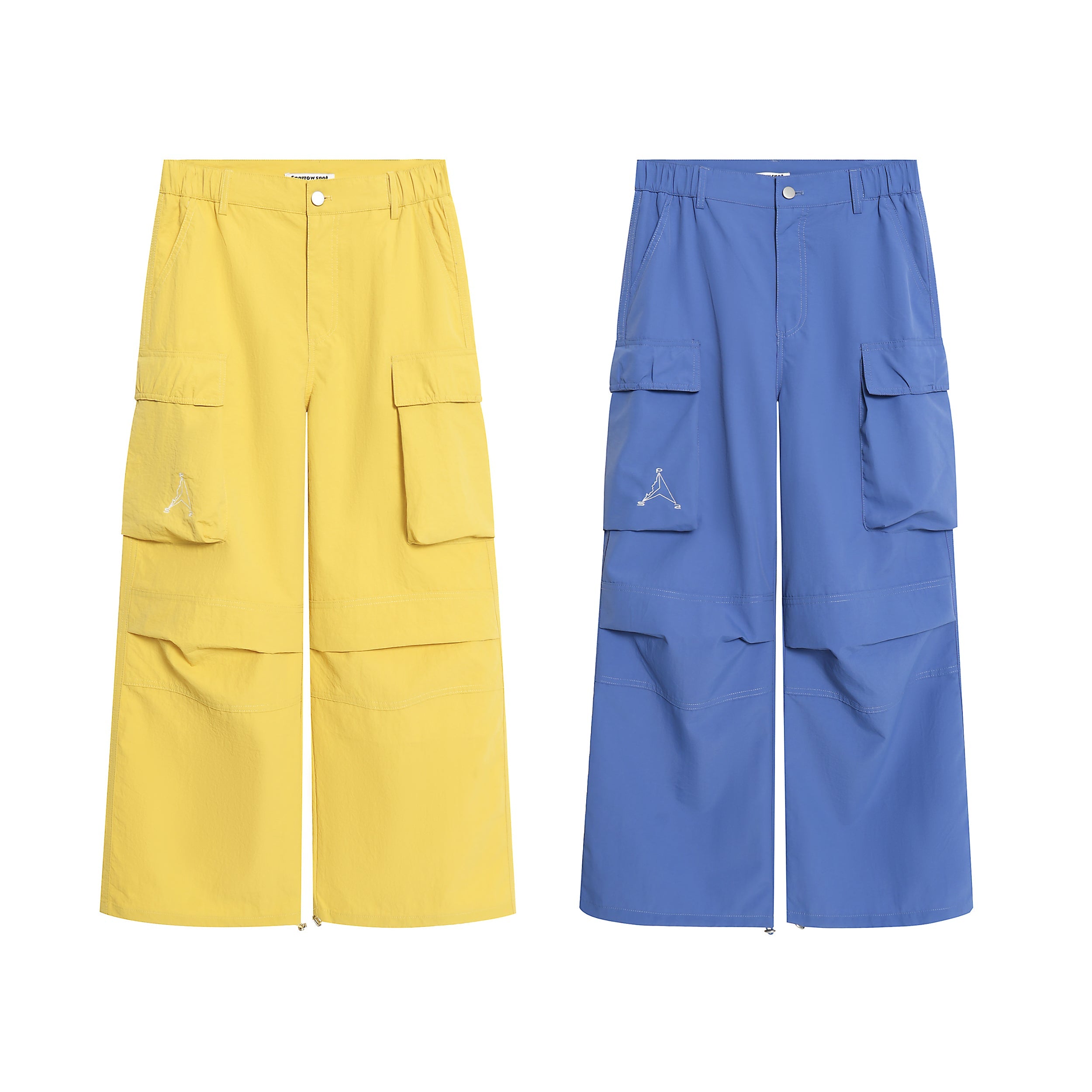 Yellow and blue wide-leg nylon cargo pants with oversized flap pockets, zip hems, and embroidered logo detail