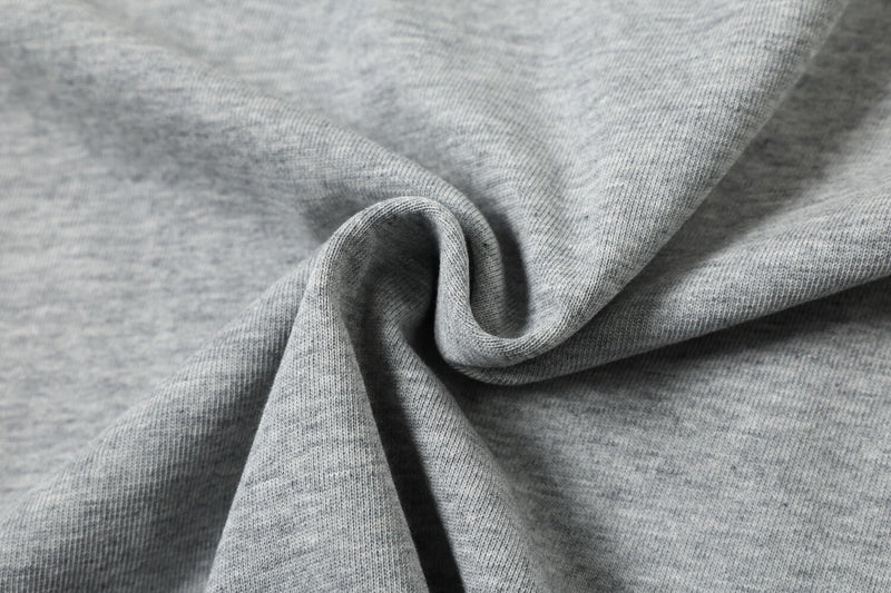 Close-up of soft gray knit fabric with gathered fold texture