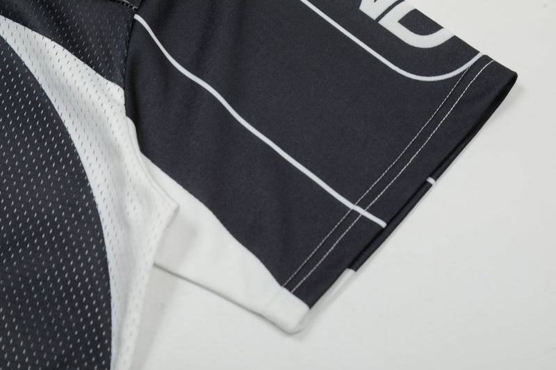 Black and white mesh jersey sleeve with bold logo print and stitched hem detail
