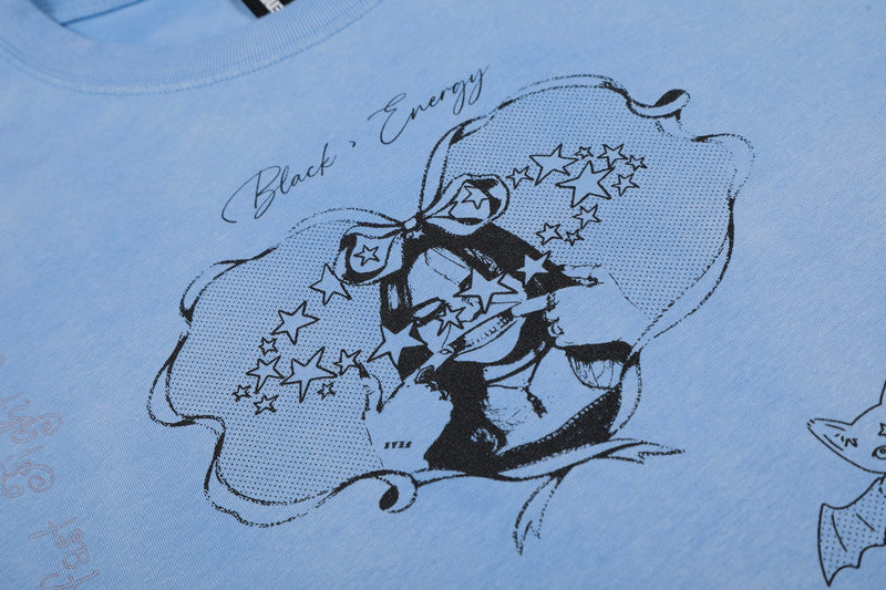 Light blue streetwear tee with black sketch-style bow graphic, stars, and handwritten energy text on cotton fabric