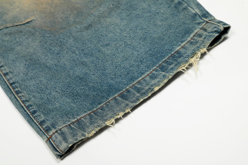 Close-up of frayed hem on light-wash wide-leg denim jeans
