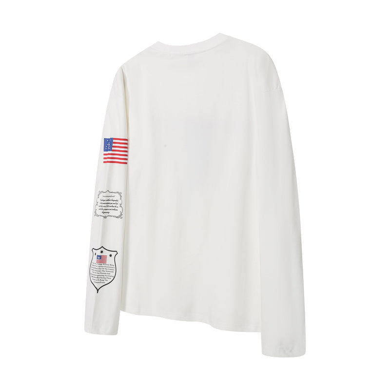 Back view of white long sleeve tee with flag graphic on one sleeve and small printed text near the cuff