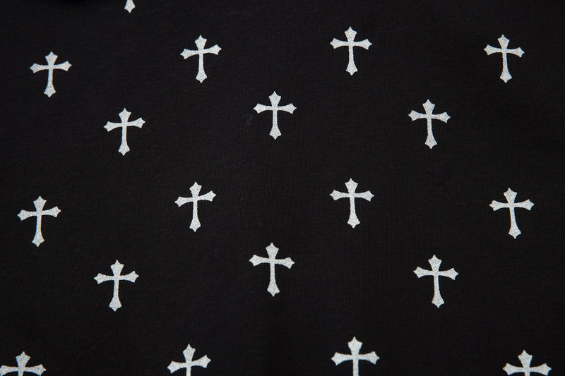 Close-up of black jacket fabric with repeated white cross print