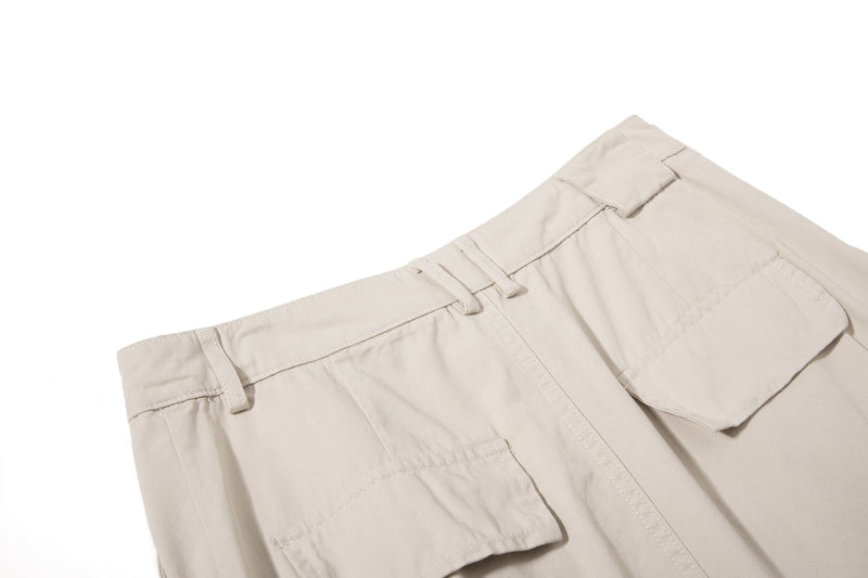 Close-up of beige cargo pants waistband and front pocket top