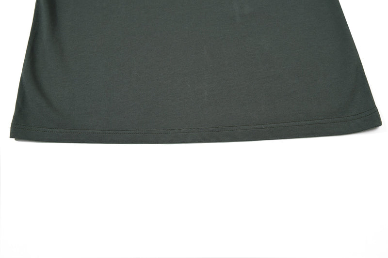 Dark green vintage graphic polo tee hem with clean double stitching on a plain white background