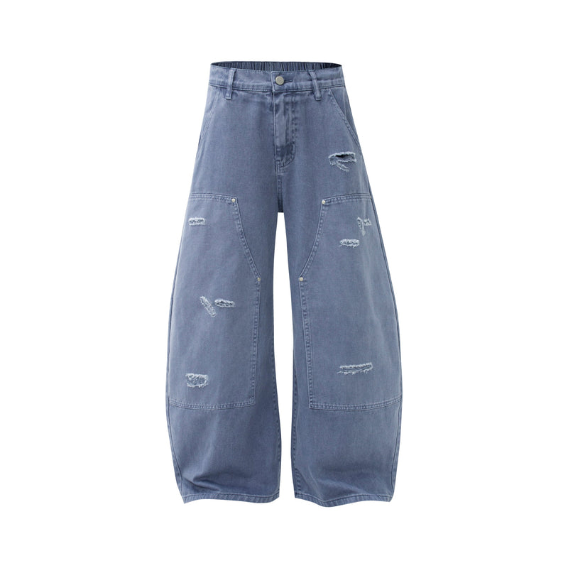 Front view of blue wide leg jeans with distressed details and large patch pockets