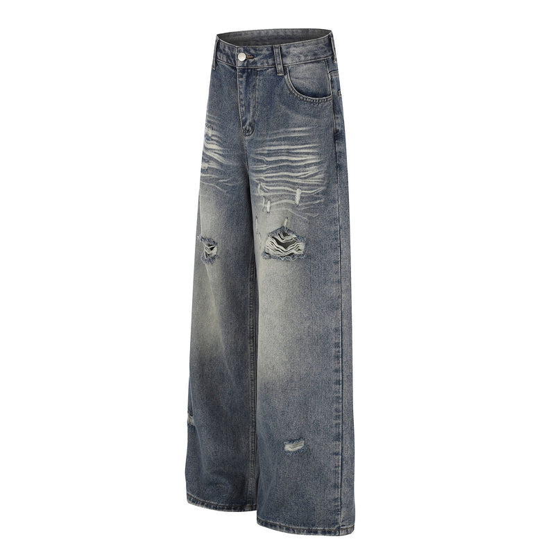 Angled front view of blue wide-leg jeans with faded wash and distressed knees