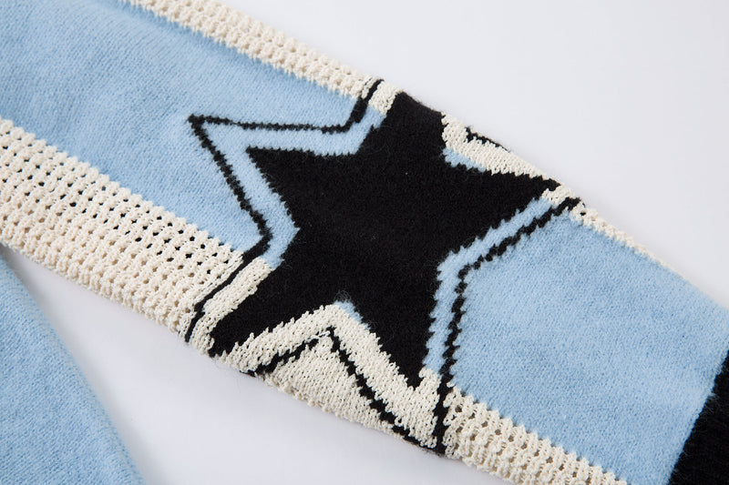 Close-up of star graphic on light blue sleeve of knit sweater