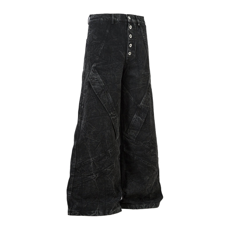 Side view of black wide-leg jeans with crinkled denim texture and button fly